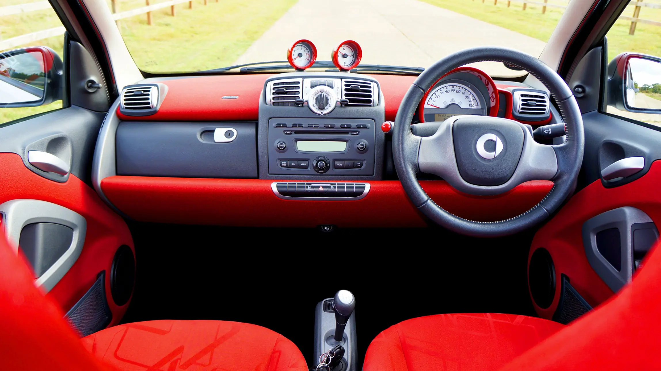 Red Smart Car interior during Smart Car maintenance and repair service in Fort Worth, TX focused on AMT transmission diagnostics and clutch calibration