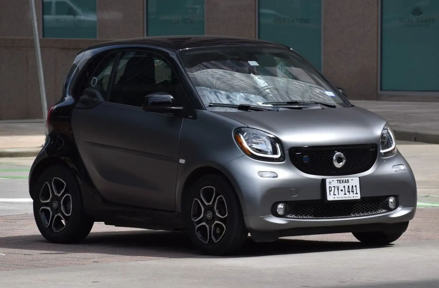 Dark gray two-door Smart Car during Smart Car maintenance and repair service in Fort Worth, TX inspecting cooling system and electronic diagnostics